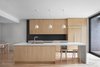 Modern home with Kitchen, Wood Cabinet, Mosaic Tile Backsplashe, Refrigerator, Drop In Sink, Light Hardwood Floor, and Pendant Lighting. Naturehumaine used maple plywood and white accents throughout Des Érables Residence, striking contrast with the original wood moldings of the building. Photo 8 of Des Érables Residence