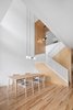 Modern home with Dining Room, Light Hardwood Floor, Table, Pendant Lighting, and Chair. Living areas in Des Érables Residence revolve around the double-height dining room. Naturehumaine sought to “modulate a degree of intimacy according to the usage.” Photo 2 of Des Érables Residence