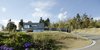 Modern home with Exterior, House Building Type, and Flat RoofLine. A private road leads to the expansive southeast-facing slope upon which the house sits. Directly adjacent is a grove of fruit trees and a verdant meadow. Photo 7 of Where the Eagles Live