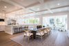 Modern home with Kitchen, Recessed Lighting, Wood Cabinet, Ceiling Lighting, Medium Hardwood Floor, White Cabinet, Ceramic Tile Backsplashe, and Marble Counter. “This house is a mix of traditional architecture with contemporary open areas,” says architect Joe Spierer. “We integrated many expansive glass windows and doors, and attained a cleaner look without all the wainscoting and with less fussy molding." Photo 2 of Sorrento