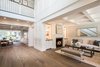 Modern home with Hallway and Medium Hardwood Floor. Built on three levels, the main floor openly flows from the 18’ ceiling entryway to the gourmet chef's kitchen and family room. Photo 4 of Sorrento