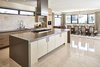 Modern home with Kitchen, Wood Cabinet, Range Hood, Ceiling Lighting, Subway Tile Backsplashe, and Undermount Sink. Throughout the house, the reflection of polished tile floors add to its bright, airy feel. Photo 5 of Via Victoria