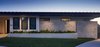 Modern home with Exterior, Stucco Siding Material, House Building Type, Wood Siding Material, Flat RoofLine, Stone Siding Material, and Metal Roof Material. Built into a hillside, the house appears to be one level streetside, but is actually two levels. Photo 7 of Via Victoria