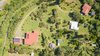 Property overview - Main House, Water Tank, Art Studio, Barn (white roof), Cottage (red roof) Photo 14 of Tropical Sanctuary modern home