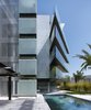 Modern home with Exterior, Glass Siding Material, Wood Siding Material, House Building Type, and Stone Siding Material. The façades rotated 45º with respect to the orthogonal limits of the plot. Photo of Madroños 27