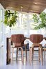 Modern home with Kitchen, Pendant Lighting, Wood Counter, Concrete Floor, Ceiling Lighting, Engineered Quartz Counter, and Recessed Lighting. Modern pool house, designed by JBellessa Design. Indoor-outdoor living. Barstools: Room and Board Photo 10 of Modern Mountain Pool House