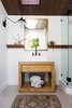 Modern home with Concrete Floor. Custom woodwork adds helpful shelving in the bathroom, while a long skylight draws in natural light. Photo 14 of Modern Mountain Pool House
