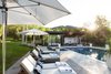 Modern pool house exterior with chaise lounges, designed by JBellessa Design. Indoor-outdoor living. Photo 18 of Modern Mountain Pool House modern home