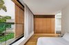 Modern home with Bedroom, Ceiling Lighting, Bed, Medium Hardwood Floor, and Night Stands. Master bedroom features sliding windows and privacy screens that span the width of the home. Photo 11 of Cloud House