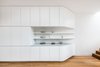 Modern home with Living Room, Ceiling Lighting, Medium Hardwood Floor, Recessed Lighting, and Bookcase. Custom cabinetry creates seamless kitchen and living storage solutions. Photo 17 of Cloud House