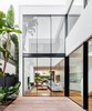 Modern home with Outdoor, Side Yard, Wood Patio, Porch, Deck, Trees, and Pavers Patio, Porch, Deck. The internal courtyard looks into the living, dining and kitchen space of the home's ground floor. Photo 15 of Cloud House