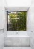 Modern home with Bath Room, Marble Wall, Marble Counter, Open Shower, One Piece Toilet, Soaking Tub, Marble Floor, Drop In Sink, and Ceiling Lighting. Bathroom features Carrara Marble flooring and walls. Window slides open on to garden foliage. Photo 7 of Cloud House