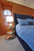Modern home with Bedroom, Night Stands, Storage, Shelves, Table Lighting, Bed, and Recessed Lighting. Michael Molesky Interior Design. Modern master bedroom in a DC townhouse. Bright blues play well with the rich panelling which conceals wardrobe storage. Photo 11 of Historic Townhouse Made Modern
