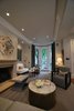 Modern home with Living Room, Floor Lighting, Bench, Sofa, Chair, Medium Hardwood Floor, Ottomans, Coffee Tables, End Tables, Wood Burning Fireplace, Table Lighting, Standard Layout Fireplace, and Recessed Lighting. Michael Molesky Interior Design. Modern living room in a historic DC townhouse. Multi-tone grays and rich textures create an elegant and comfortable feel. Photo 4 of Historic Townhouse Made Modern