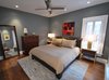 Modern home with Bedroom, Medium Hardwood Floor, Chair, Bed, Ceiling Lighting, Recessed Lighting, Dresser, and Night Stands. Michael Molesky Interior Design. Modern guest bedroom in a DC townhouse. New dark paint, bedding, beside tables, lamps and rug were brought in to compliment the client's existing bed, chair and dresser. Photo 7 of Historic Townhouse Made Modern