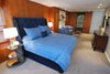 Modern home with Bedroom, Bench, Bed, Wardrobe, Night Stands, Storage, Dresser, Table Lighting, Chair, and Recessed Lighting. Michael Molesky Interior Design. Modern master bedroom in a DC townhouse. Bright blues play well with the rich panelling which conceals wardrobe storage. Photo 8 of Historic Townhouse Made Modern