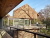 Modern home with Exterior, Metal Roof Material, Wood Siding Material, Flat RoofLine, Glass Siding Material, House Building Type, and Gable RoofLine. View from outdoor porch by Low Design Office Photo of Guadalupe River House