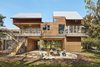 Modern home with Exterior, House Building Type, Gable RoofLine, Wood Siding Material, Metal Siding Material, Flat RoofLine, Glass Siding Material, and Metal Roof Material. View of house from Guadalupe River side by Low Design Office Photo 2 of Guadalupe River House