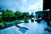 Modern home with Outdoor, Large Patio, Porch, Deck, Hardscapes, Gardens, Shrubs, Grass, Trees, Back Yard, Horizontal Fences, Wall, and Stone Patio, Porch, Deck. A look at the Patio and Backyard Photo 2 of Casa Gonzalez-Herrero