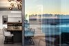 Modern home with Dining Room, Light Hardwood Floor, Table, Stools, Bar, Chair, and Pendant Lighting. “Our first objective was to individualize the space …with a quiet opulence.” - Adam Court, OKHA Photo 2 of Clifton 301