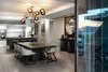 Modern home with Dining Room, Table, Pendant Lighting, Light Hardwood Floor, Chair, Bar, and Stools. Dream Emperor Marble and Absolute Black Granite tabletops are paired with steel bases in
the side, coffee and balcony tables. The dining table, barstools and server are hewn from carbon-stained wire brushed Ash timber, also used in the frame of signature OKHA “Port” mirror, which, with its copper framed recessed mirror carries a nautical tone of a ship’s circular windows. Photo 8 of Clifton 301