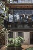 Modern home with Outdoor, Gardens, Large Patio, Porch, Deck, and Front Yard. The mirrored glass creates a game of reflections between the old and new elements. Photo 7 of Lirio 7