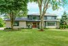 Modern home with Exterior, Mid-Century Building Type, Wood Siding Material, House Building Type, Shingles Roof Material, and Stone Siding Material. Dorchester Front Exterior Photo of The Dorchester Project by Paul + Jo Studio