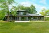 Modern home with Exterior, Shingles Roof Material, House Building Type, and Wood Siding Material. Dorchester Back Exterior Photo 4 of The Dorchester Project by Paul + Jo Studio