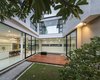 Modern home with Outdoor, Wood Patio, Porch, Deck, Landscape Lighting, Shrubs, Grass, Back Yard, Decking Patio, Porch, Deck, Gardens, Hardscapes, and Trees. View from courtyard toward the house Photo 11 of SIRI House