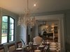 Modern home with Dining Room, Table, Ceiling Lighting, Chair, Medium Hardwood Floor, and Gas Burning Fireplace. Looking from the Dining room, through the Foyer, and into the study. A very traditional, southern feel in these rooms, with a touch of modern.
Dining room with paneled walls and crystal chandelier. Foyer with custom painted wood floor, antique French crystal sconces, and an heirloom table from my Grandparents. Study with fireplace, crystal orb chandelier and a built in bourbon bar. (Still waiting on some furniture, décor and rugs in these photos) Photo 3 of Detailed by Design