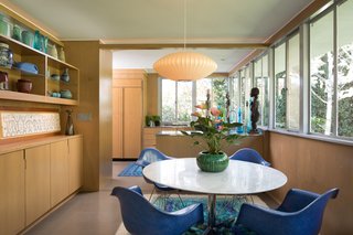 The dining room now occupies the space that was once the kitchen. The renovation opened up walls and added a credenza for serving. Originally, Lukens had requested lots of shelving for his ceramics. 
