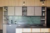 Modern home with Kitchen, Metal Cabinet, Ceramic Tile Floor, Laminate Counter, and Marble Backsplashe. subtle metal construction was designed for kitchen display and cabinets , backsplash is green marble Verde Guatemala Photo of Mountain Apartment in Ore Mountain, Czech Republic