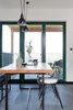 Modern home with Dining Room, Pendant Lighting, Table, and Ceramic Tile Floor. custom made dinign table from solid oak wood with "life edge" Photo 5 of Mountain Apartment in Ore Mountain, Czech Republic