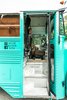 Modern home with Exterior, Metal Siding Material, Tiny Home Building Type, Metal Roof Material, and Flat RoofLine. The entryway, refreshed but mainly original. You can see the black co-pilot seat we installed to the left, bolted to the front cage. Photo 9 of The Wild Drive Life Bus