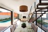 Modern home with Staircase, Wood Tread, and Metal Railing. Living room space, integrated between a horizontal relation of external areas. Photo 6 of QP House