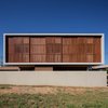 Modern home with Exterior, House Building Type, Wood Siding Material, and Flat RoofLine. Closer look at the wooden bride-soleil, structured by metal frames and "cumaru" type clapboard. Photo 2 of QP House