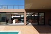 Modern home with Living Room, Floor Lighting, Sofa, Wall Lighting, Chair, Ceiling Lighting, and Ceramic Tile Floor. Longitudinal implantation takes advantage of the natural ventilation and light, with sliding glass doors serving as an interface between inside and outside. Photo 5 of QP House