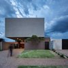 Modern home with Exterior, Stucco Siding Material, House Building Type, and Flat RoofLine. Front windowless facade, strategically positioned by a sunlight demand, imposing a strong geometric scale. Photo 9 of QP House