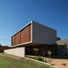 Modern home with Exterior, Stucco Siding Material, Flat RoofLine, Wood Siding Material, and House Building Type. Front and morning side facade, protected by wooden brise-soleil. Photo 4 of QP House