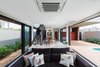 Modern home with Living Room, Chair, Bookcase, Sofa, Ceiling Lighting, and Ceramic Tile Floor. Steel “waterfall” style shaped staircase, visually unattached, allows unobstructed view of the entire living space. Photo 8 of QP House