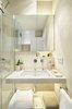 Modern home with Bath Room, Stone Tile Wall, Corner Shower, Undermount Sink, One Piece Toilet, Tile Counter, Freestanding Tub, Recessed Lighting, and Ceramic Tile Floor. Bathroom in a pale palette Photo 9 of remodelled duplex in a contemporary style