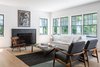 Modern home with Living Room, Light Hardwood Floor, Chair, Standard Layout Fireplace, Ceiling Lighting, Sofa, and Coffee Tables. Living 02 Photo 8 of New Canaan Home