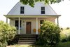 Modern home with Exterior, House Building Type, Wood Siding Material, Farmhouse Building Type, Gambrel RoofLine, and Shingles Roof Material. This front porch is North facing, so is typically partially shaded throughout the day. An ideal spot for morning coffee and a book. Photo of Modern Farmhouse