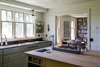 Modern home with Kitchen, Microwave, Recessed Lighting, Refrigerator, Range, Wall Oven, Colorful Cabinet, Dishwasher, Drop In Sink, and Light Hardwood Floor. Custom kitchen island and storage fronts bring a uniqueness and functionality to this aesthetically pleasing space. Photo 2 of Modern Farmhouse