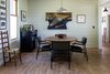 Modern home with Dining Room, Bar, Ceiling Lighting, Light Hardwood Floor, Table, Chair, and Wood Burning Fireplace. Dining area table Photo 6 of Modern Farmhouse