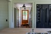 Modern home with Hallway and Light Hardwood Floor. The rear entryway hall has drawers, half closets and gym locker room baskets for jackets, shoes, gloves and whatever else you might need on your way out the door. Photo 8 of Modern Farmhouse