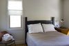 Modern home with Bedroom, Ceiling Lighting, Storage, Chair, Night Stands, Wardrobe, Carpet Floor, Lamps, Bed, and Accent Lighting. First floor bedroom Photo 9 of Modern Farmhouse