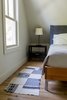 Modern home with Bedroom, Light Hardwood Floor, Ceiling Lighting, Chair, Bed, and Storage. Second upstairs bedroom Photo 14 of Modern Farmhouse