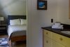 Modern home with Bath Room, Wood Counter, Two Piece Toilet, and Light Hardwood Floor. Dressing area with sink and attached bathroom second upstairs bedroom Photo 15 of Modern Farmhouse