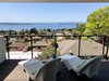 Modern home with Outdoor, Trees, Back Yard, Decking Patio, Porch, Deck, Wood Patio, Porch, Deck, and Wire Fences, Wall. Master bedroom deck exemplifies capturing the view. Photo 17 of Farwell